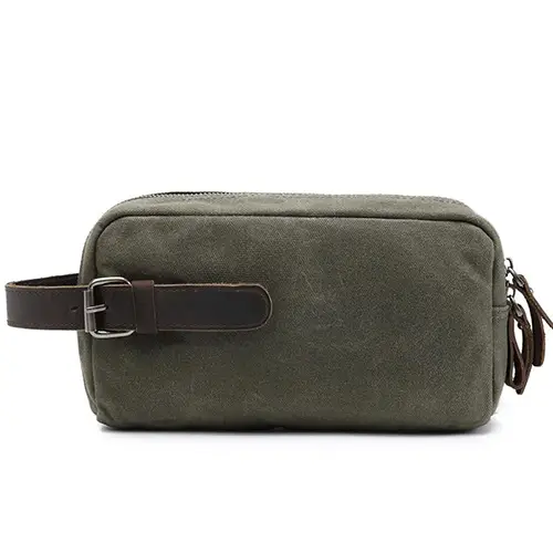 Custom hanging travel toiletry bag in graphite gray hanging on a small hotel bathroom rack to save space